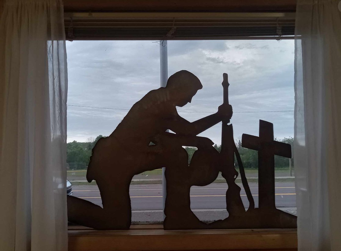 Kneeling soldier remembrance silhouette in the hall window